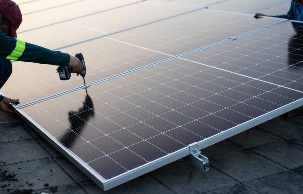Technician fixing and assembling solar panels